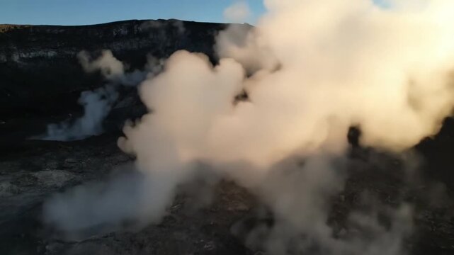 Volcanic crater with steam vents and fumaroles at sunrise