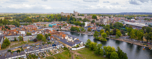 Aerial view of Windsor Castle surrounded by town buildings and lush green landscape