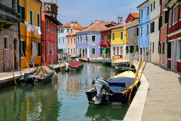 Colorful houses by canal in Burano, Venice, Italy.