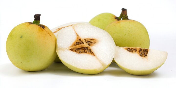 Star apples, some sliced open, against a clean white background, displaying their intricate star-shaped pattern.