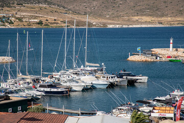 Various yachts anchored in the harbor. A small district harbor. Alaçatı, Çeşme, Izmir