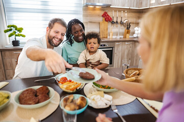 Family enjoys a cozy meal together in a warm kitchen setting