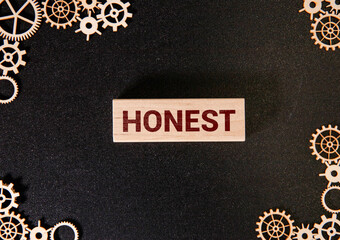 Honesty message written on torn cardboard paper with red background.