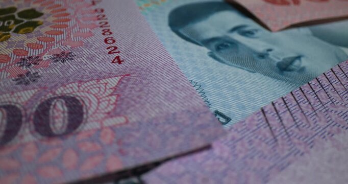 Close-up view of banknotes displaying intricate designs and details in vibrant colors and patterns