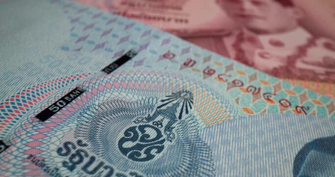 Explore the details of Thai currency with a close-up of a 20 baht bill showcasing intricate designs and symbols from Thailand