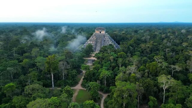 Aerial view of the mayan pyramid of kukulcan at chichen itza, surrounded by lush green jungle, revealing ancient history