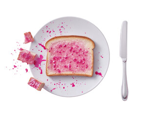 A single slice of white bread, topped with pink jam, sits on a white plate.  Crumbs and splashes of pink jam are scattered around the bread. A butter knife rests beside the plate