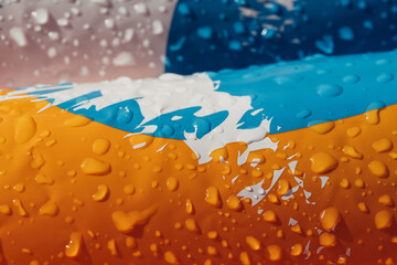 A flag with a white stripe and orange and blue colors