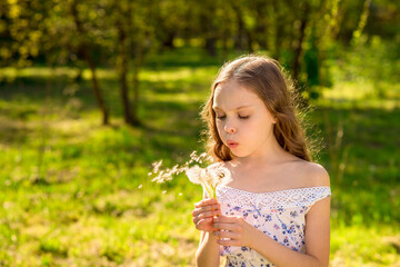 portrait of beautiful little girl with dandelion outdoor.