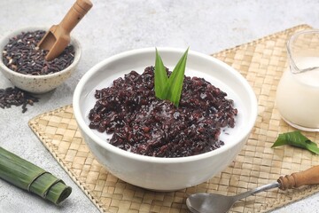 Bubur ketan hitam, bubur injit, bubur pulut hitam. Black sticky rice porridge is a dessert, with a sweet taste, made from sticky rice boiled with excess water until soft, and usually served with cocon