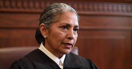Female Judge Listening Intently to Testimony in American Courtroom. Impartial.
