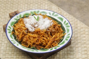 Sawut or pasrah is a snack made from coarsely grated cassava, then steamed until cooked, eaten with grated coconut.