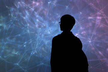 Silhouette of a young man standing in front of a projected network of lights, contemplating the complexities of modern technology in a dimly lit room.