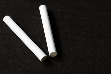 Obraz premium Dos tizas de yeso blanco sobre una superficie oscura