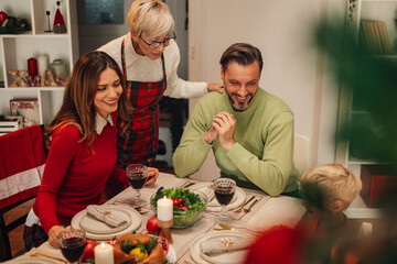 Family celebrating christmas with festive dinner at home