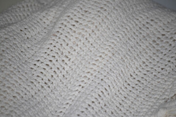 Close-up of a cozy, off-white chunky knit texture