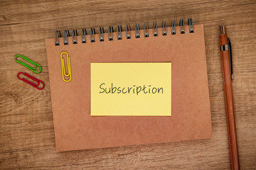 There is sticky note with the word Subscription. It is as an eye-catching image.