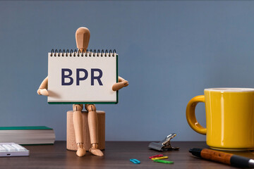 There is notebook with the word BPR. It is an abbreviation for Business Process Re-engineering as...