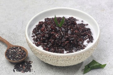 Bubur ketan hitam, bubur injit, bubur pulut hitam. Black sticky rice porridge is a dessert, with a sweet taste, made from sticky rice boiled with excess water until soft, and usually served with cocon