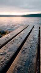 Obraz premium Tranquil Lakeside Dock with Water Drops at Sunset Reflections