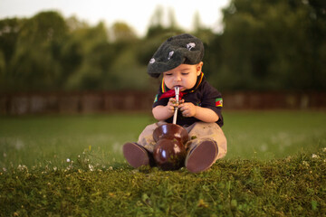 Baby boy dressed as a gaucho with a chimarrão gourd