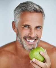 Smiling man holding a green apple