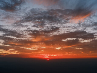 Fototapeta premium Dramatic Sunset Over Horizon with Vibrant Orange and Blue Sky