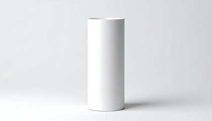 A blank, cylindrical, white object stands on a plain white surface