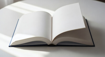 Open Book on White Table in Sunlight: Blank Pages, Ready for Stories