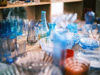 Assorted Blue Glassware on Wooden Table – Vintage Glass Cups, Bowls, and Vases