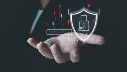 A person holds a glowing digital shield and lock icon, symbolizing cybersecurity and data protection with a password prompt over their hand on a dark background.