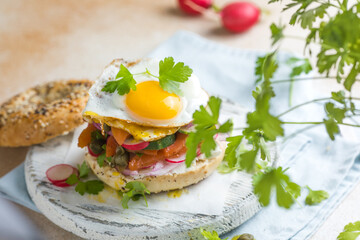 Bagel with salmon, egg, and fresh greens