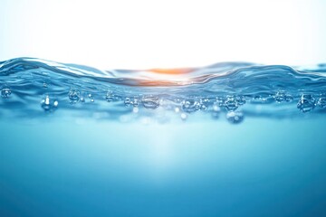 Close-up view of clear blue water surface with air bubbles rising and sunlight reflecting warmly creating a calm and refreshing atmosphere
