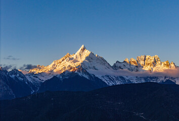 Aerial view of the Golden Mountain bathed in sunlight on Meili Snow Mountain in Yunnan Province	