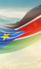 South Sudan national flag for poster. The flag waving in beautiful clouds with vertical layout....