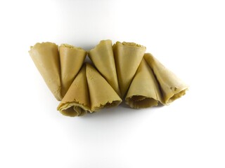 Semprong cake, sapit, sepit, Dutch cake, gapit, kassipi, kapit, Asian egg roll. A waffle or pastry snack originating from Indonesia. Semprong cake isolated on a white background.