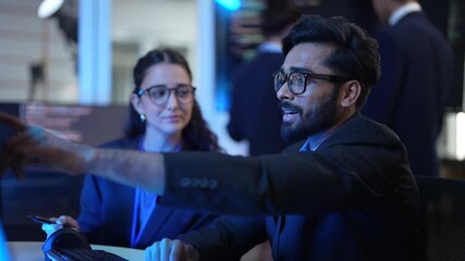 Two smart professionals discuss a new AI technology project in a modern office. They are talking about computer innovations and the future of artificial intelligence. - Powered by Adobe