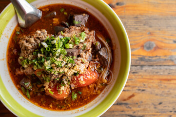 Close up of Khanom Jeen Nam Ngeow (Northern Thai Spicy Noodle Soup) served on table. Spicy Noodle Soup is influenced by Thai-Yai, now this food is an iconic northern Thai food.