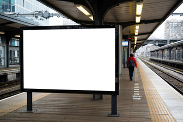 Blank white billboard on train station platform with person walking white screen
