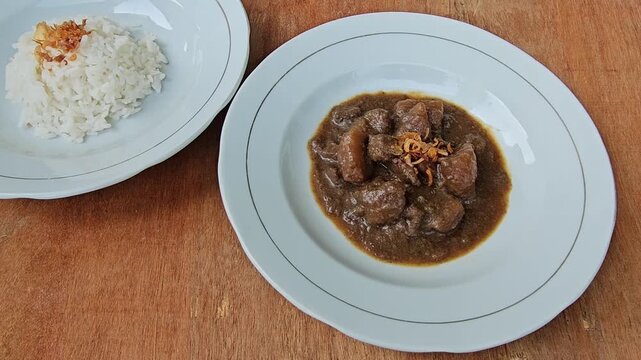 cup of coffee,Semur daging is an Indonesian meat stew in thick brown gravy,served with steamed rice