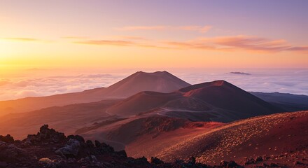 Naklejka premium A scenic view of volcanic mountains at sunset, with vibrant orange and purple hues painting the sky and landscape above the clouds.