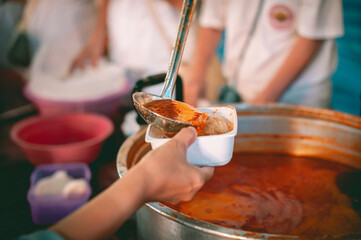 Feeding the poor to hands of a beggar Poverty concept Charity concept, hands of the poor receive...