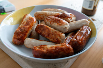 Golden Brown Pan-Fried Sausages in a Ceramic Bowl