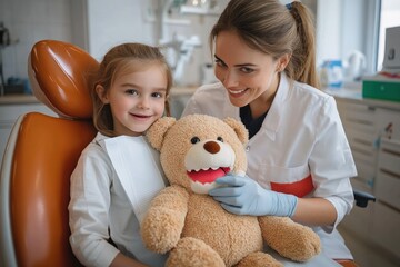 Smiling young girl sitting in dental chair with a teddy bear while a female dentist examines the toy's teeth in a cheerful dental office
