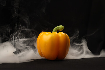 Capsicum bell pepper smoke fume vapour red yellow on black background