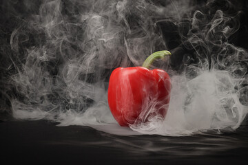Capsicum bell pepper smoke fume vapour red yellow on black background