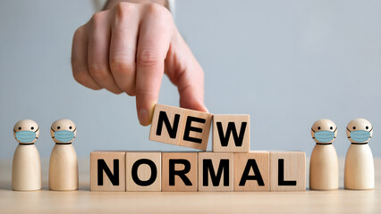 Embracing the new normal with masks and wooden blocks representing change