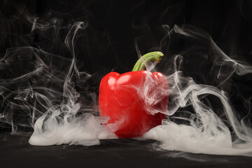 Capsicum bell pepper smoke fume vapour red yellow on black background