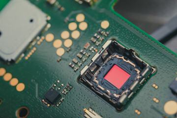 Detailed macro photo of a smartphone image sensor on a printed circuit board, showing electronic components and intricate connections.