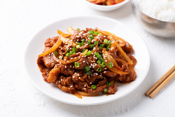 Korean stir fried spicy pork (Bulgogi) on plate with cooked rice and kimchi